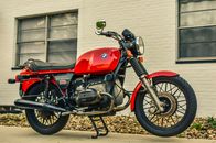Red and Black Motorcycle Parked Beside White Building