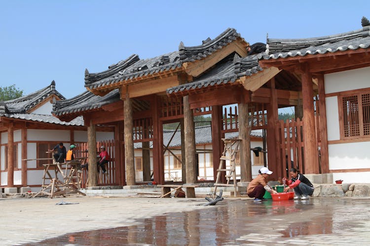 People Working On Traditional Building Site