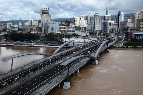 Aerial Shot of a Modern Cityscape and a Bridge