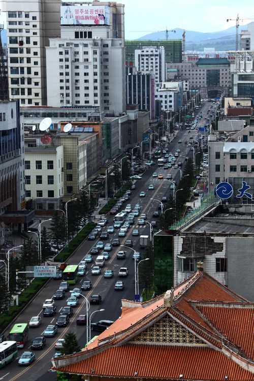 Free Busy city street with traffic and skyscrapers viewed from above. Stock Photo