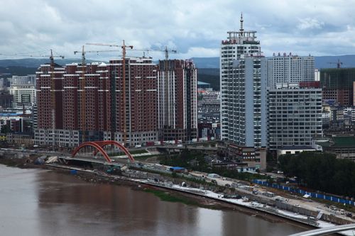 Free Aerial view of construction and urban growth in Yanji, China, featuring rising buildings. Stock Photo
