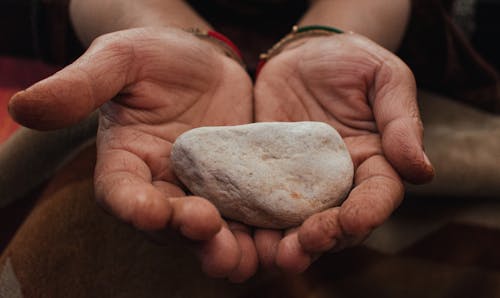 A Close-up Shot of a Person with a Stone on It's Hands