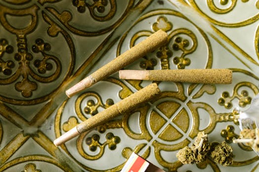 Close-up of cannabis joints on an ornate decorative tray, highlighting textures and details.