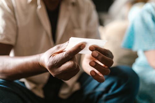 Close Up Photo of  Person Holding White Paper 