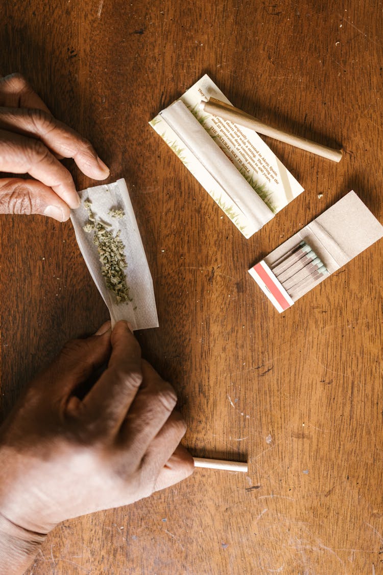 Person Rolling A Joint Of Weed 