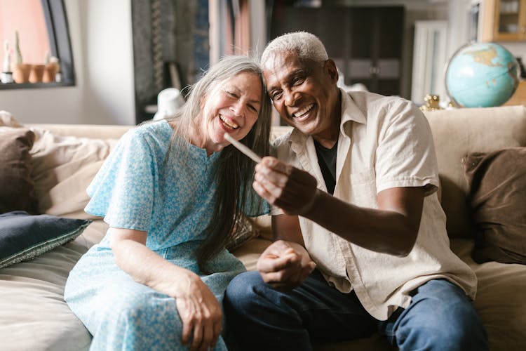 A Happy Elderly Couple Looking At A Joint