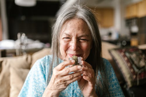 Elderly Woman Smelling Weed Up Close 