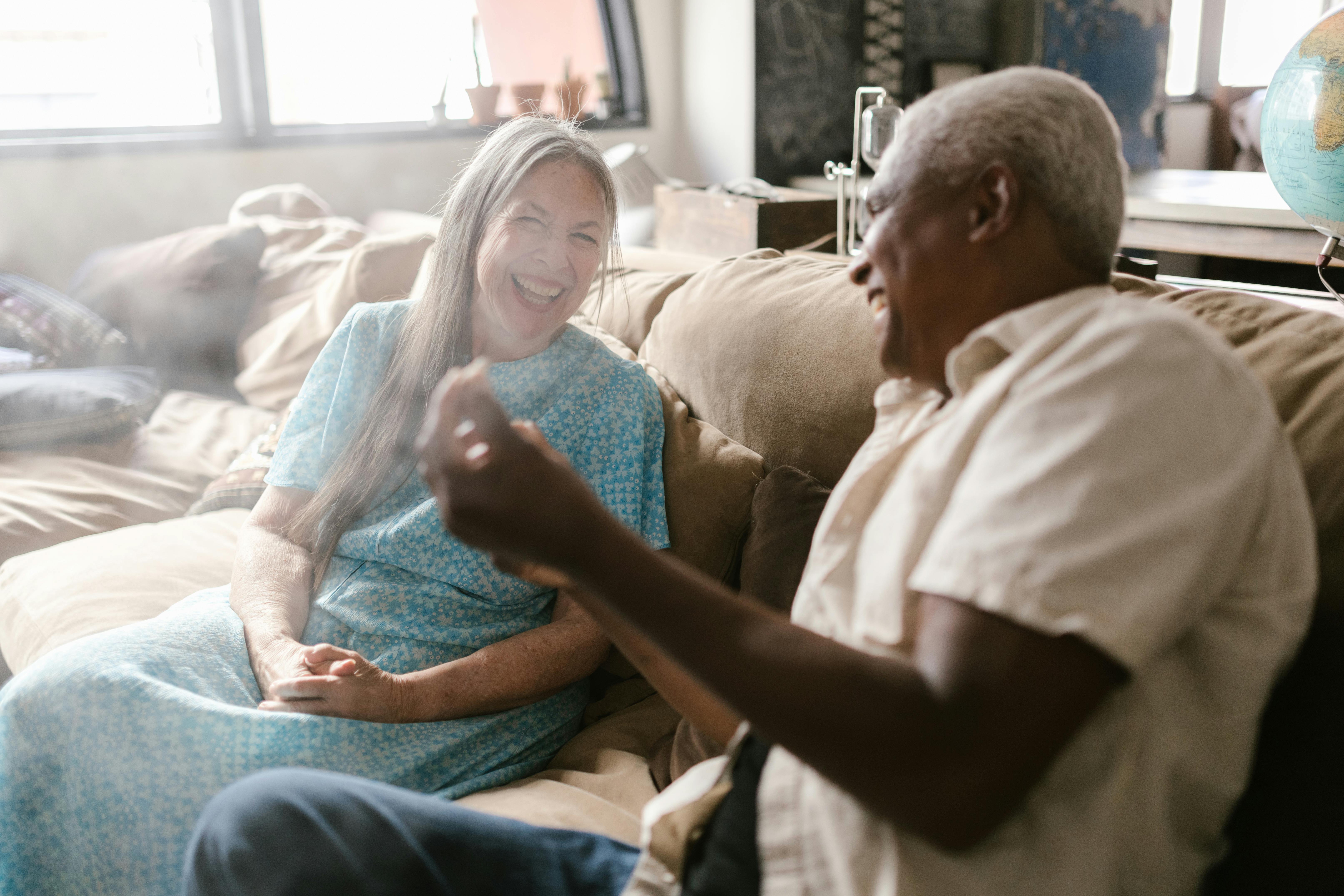 Companion and senior looking at a photo album together - Choosing home care