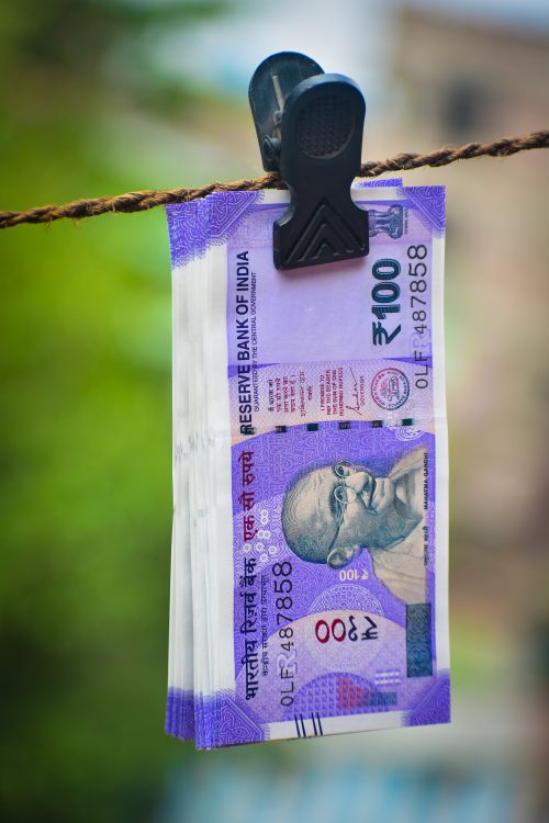 Free Close-up of Indian 100 rupee notes clipped on a clothesline outdoors in Kolkata, India. Stock Photo
