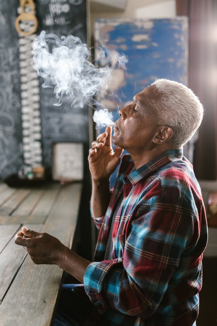 Side View Photo Of Elderly Man Smoking Pot