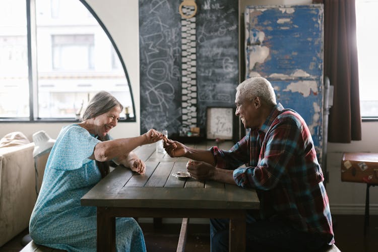 A Man And Woman Sitting At The Table 