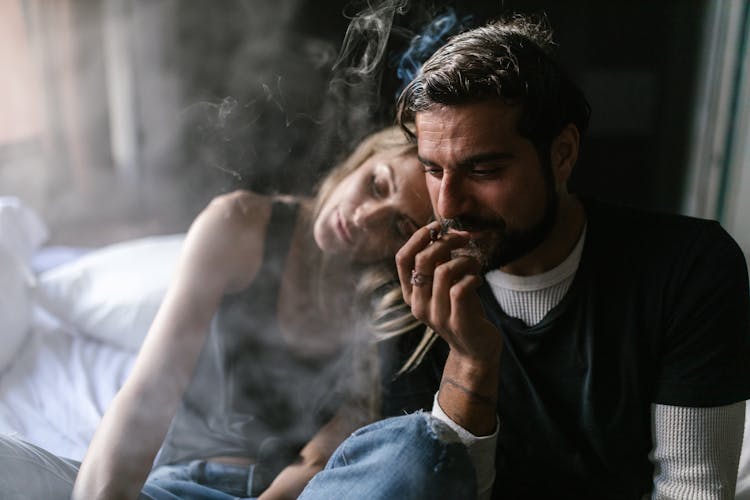 A Man In Black Shirt Smoking Weed