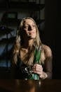 Woman Holding a Glass Bong