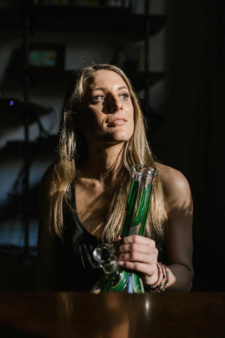 Woman Holding A Glass Bong