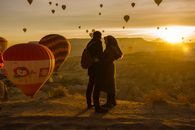 A Couple Standing Under the Hot Air Balloons