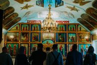 People Standing in Front of Religious Painting