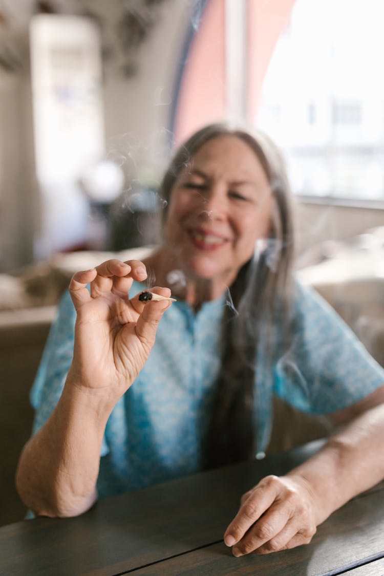 An Elderly Woman Smoking 