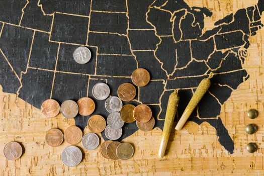 A USA map with cannabis joints and coins, symbolizing legal marijuana and its economic impact.