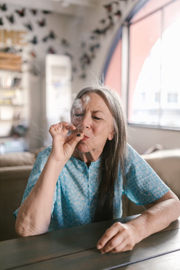 An Elderly Woman Smoking 