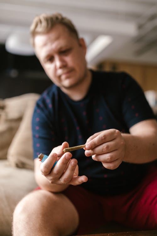 Free A Man Holding a Joint Stock Photo