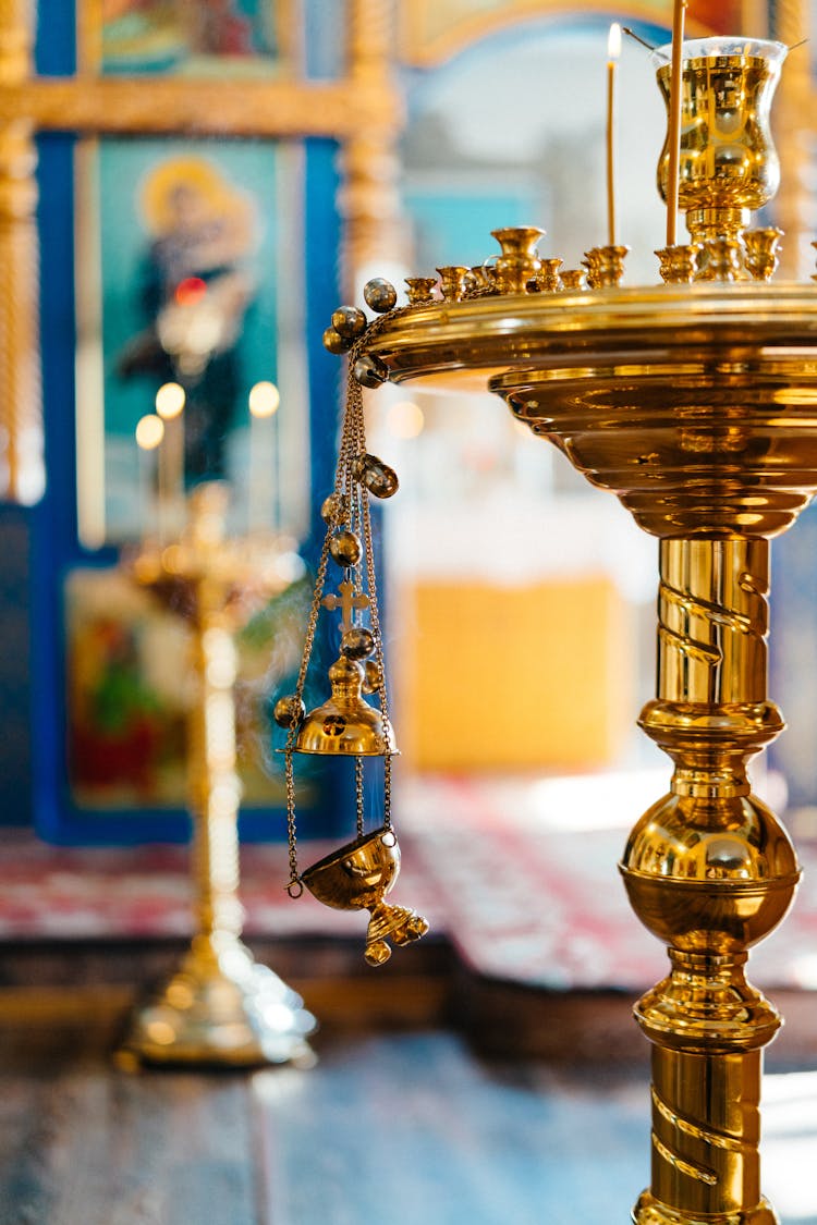 A Thurible Hanging On A Candle Holder