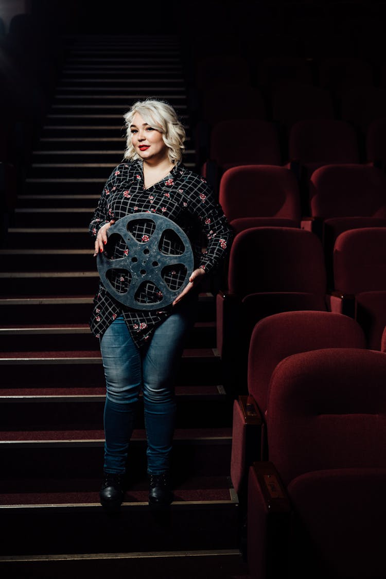 Woman With Film On Movie Theater Stairs