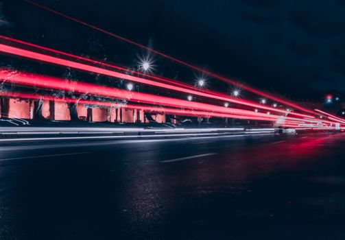 Long exposure captures vibrant streetlights and moving traffic in Rabat at night.