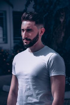 Man Wearing White T-shirt Standing Near a Tree