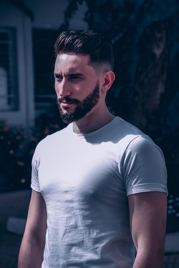 Man Wearing White T-shirt Standing Near A Tree