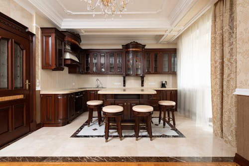 A Wooden Table and Chairs Inside the Kitchen