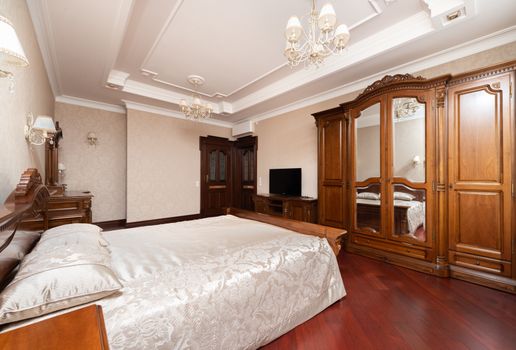 A Bed with White Linen Near the Wooden Cabinets