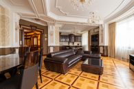 Black Leather Couch on Brown Wooden Floor