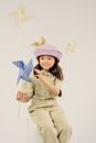 Girl in Beige Dress Holding Blue and White Umbrella