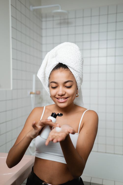 Woman Holding A Bottle Of Face Cream