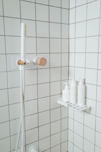 Bottle on a tiled shower shelf — photo by Ron Lach on Pexels