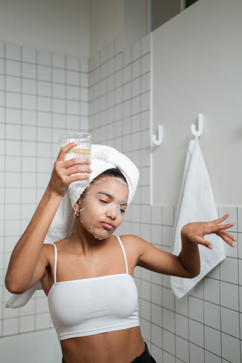 Woman Dancing In The Bathroom With Glass Of Water