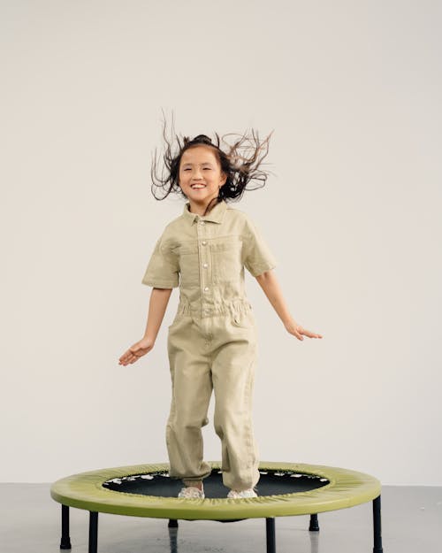 Free Girl Jumping on the Trampoline Stock Photo