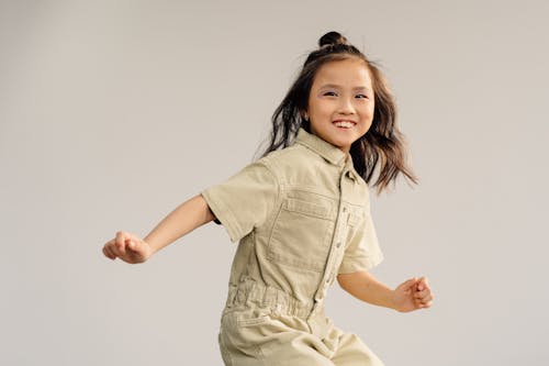 A Girl in Beige Overall Smiling