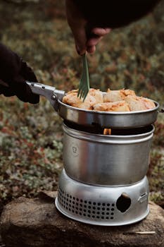 A close-up of cooking food using a portable stove outdoors in Sundsvall, Sweden.
