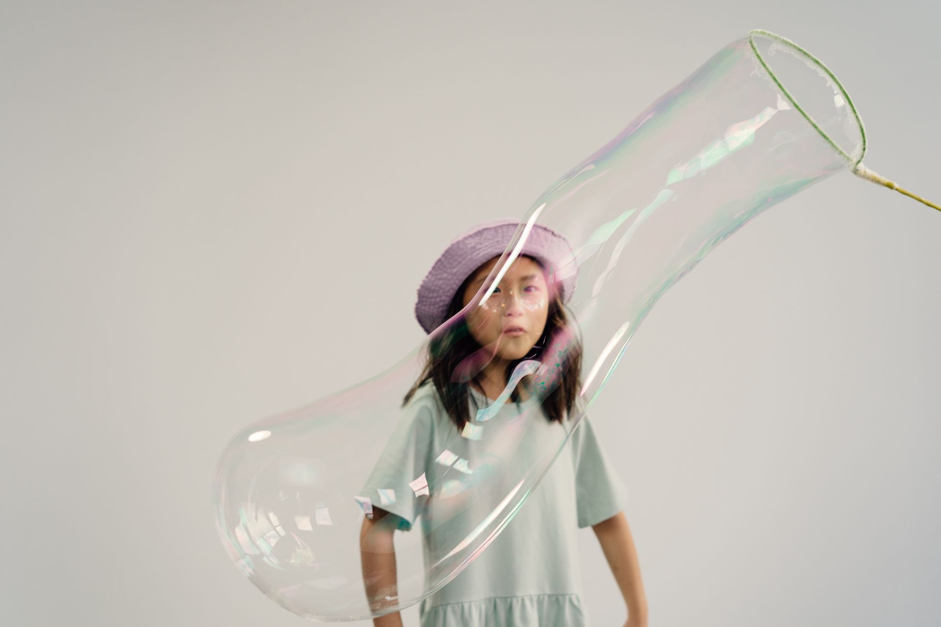 A Little Girl Looking at a Huge Bubble