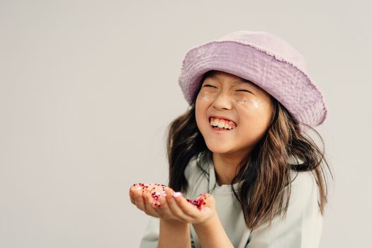 A Girl Wearing Purple Hat with Red  on Hands