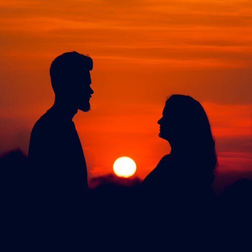 Free Silhouette of Man and Woman at Sunset Stock Photo
