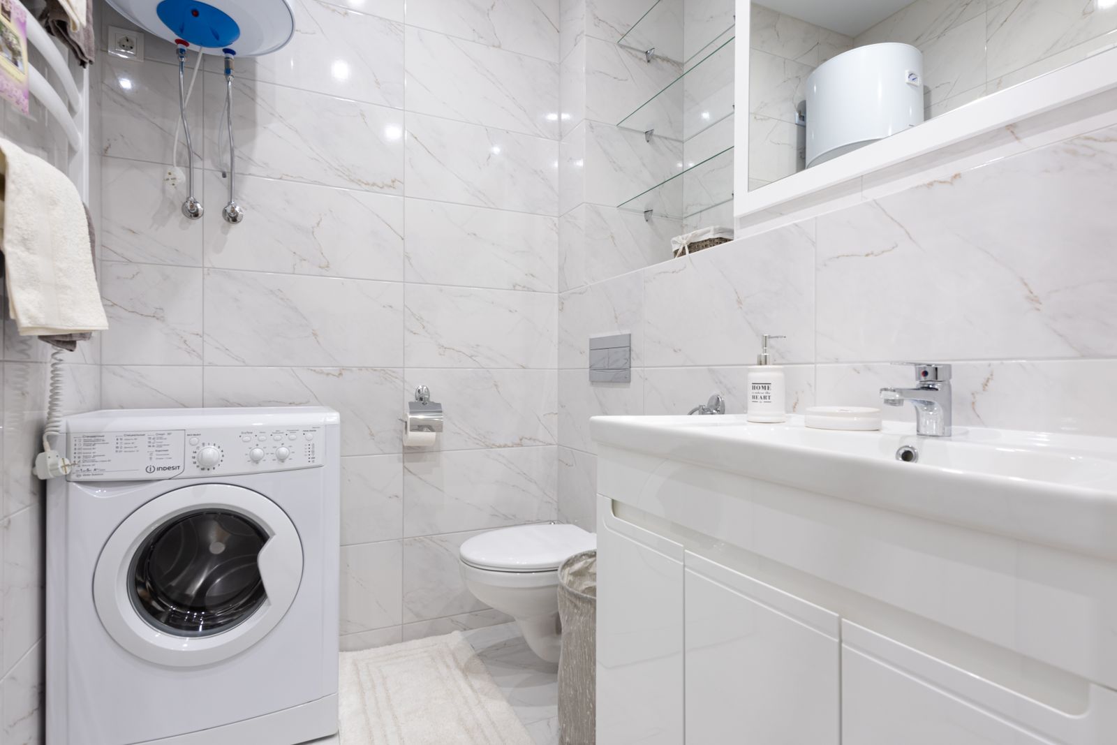 Bright utility room with a washing machine and wall-mounted fixtures