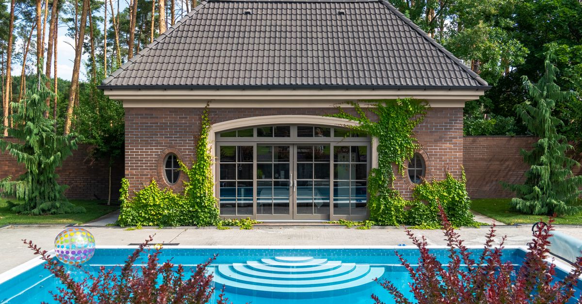 A serene garden with a modern shed and a pool, perfect for summer relaxation.