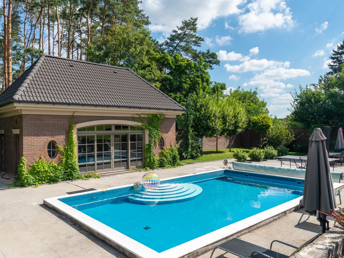 Backyard pool and patio at a brick home