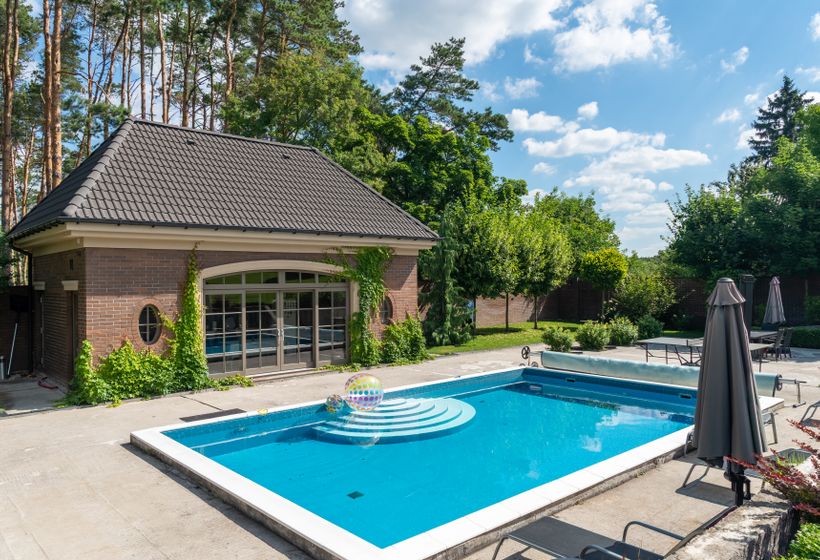 Backyard pool and patio at a brick home