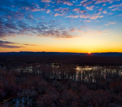 Beautiful sunset over a river landscape in Trevino, WI, United States with a vibrant sky and natural beauty.