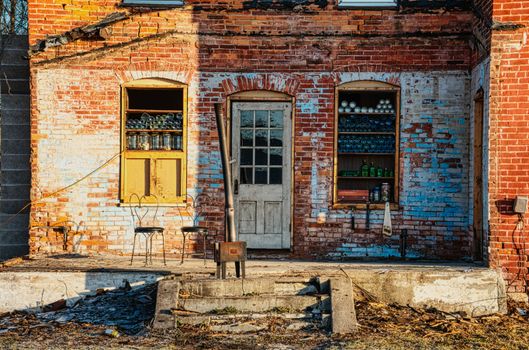 A Brown Brick House with Chairs on the Porch