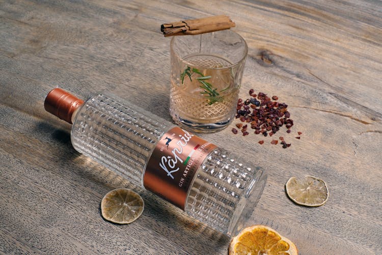 A Bottle Of Gin Lying On A Wooden Table