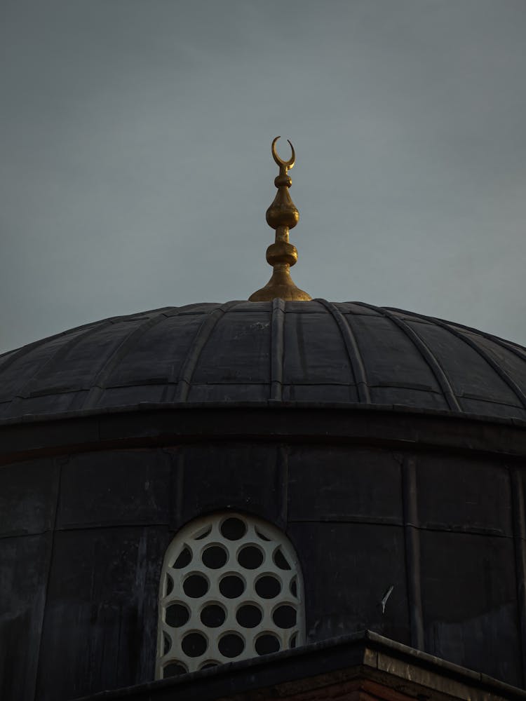 A Gray Mosque With Crescent Moon Symbol Under Gray
Sky